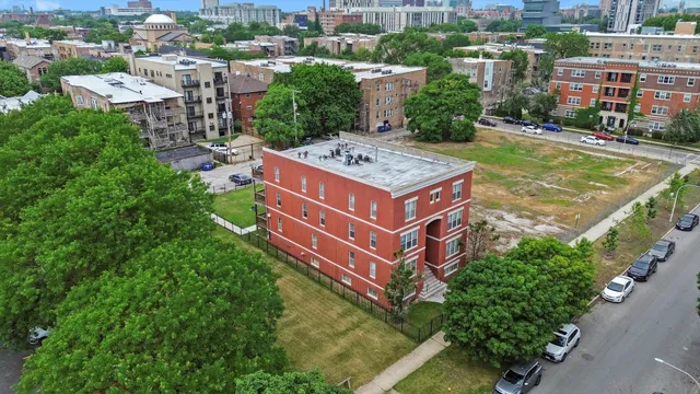 an aerial view of a house with a garden and lake view