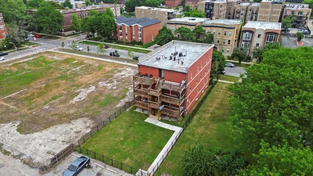 an aerial view of a house with a yard basket ball court and outdoor seating
