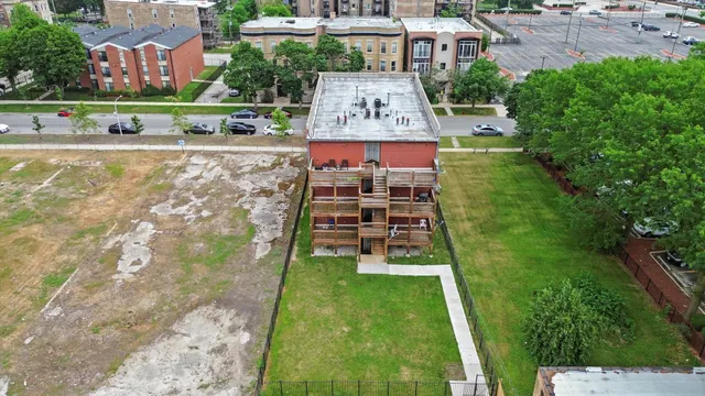 an aerial view of a house with a garden and trees