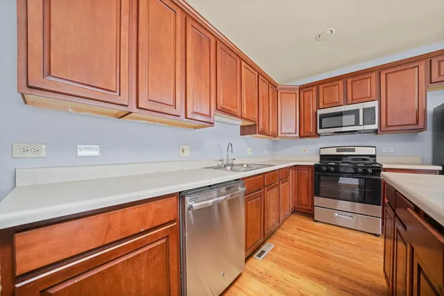 a kitchen with stainless steel appliances granite countertop a stove sink and cabinets