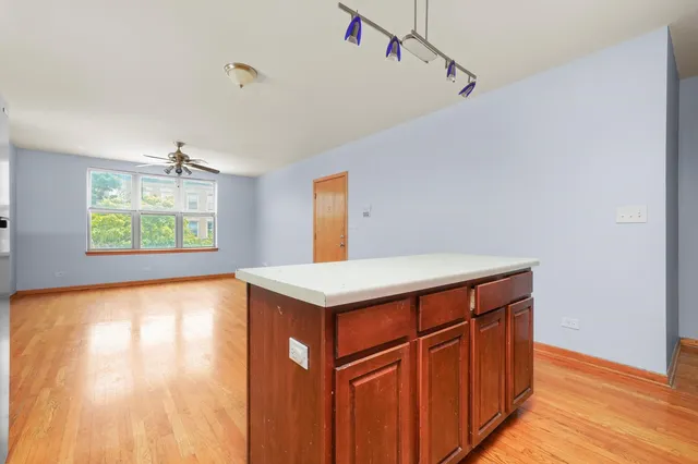 a kitchen with kitchen island wooden floor and window