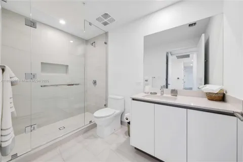 a kitchen with kitchen island stainless steel appliances a sink stove and cabinets