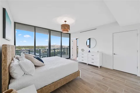 a view of a room with wooden floor and windows