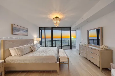 a living room with furniture and large windows