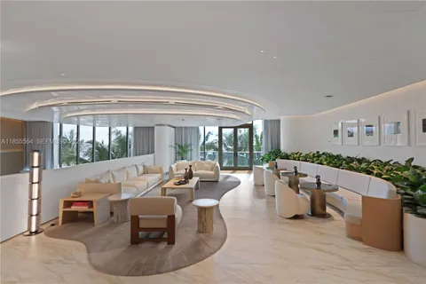 a view of a lake with lawn chairs and a big yard