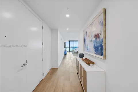 a bathroom with a toilet a sink a glass door a shower and vanity