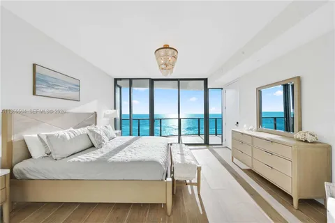 a spacious bedroom with a bed a large window with outer view and balcony view