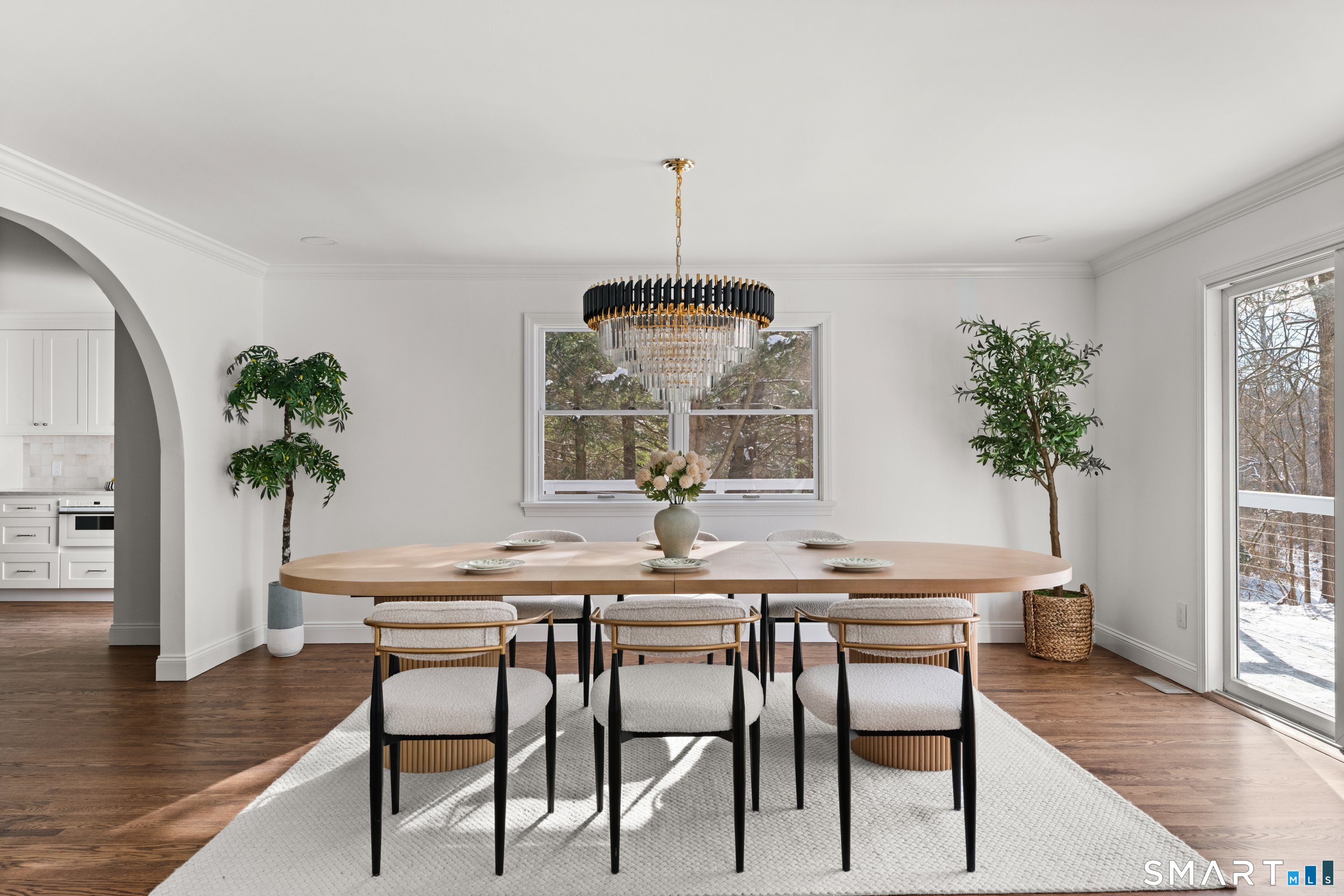 913 Ridgefield Road Wilton, CT 06897 - Photo 14 of 40 a dining room with furniture potted plants and wooden floor