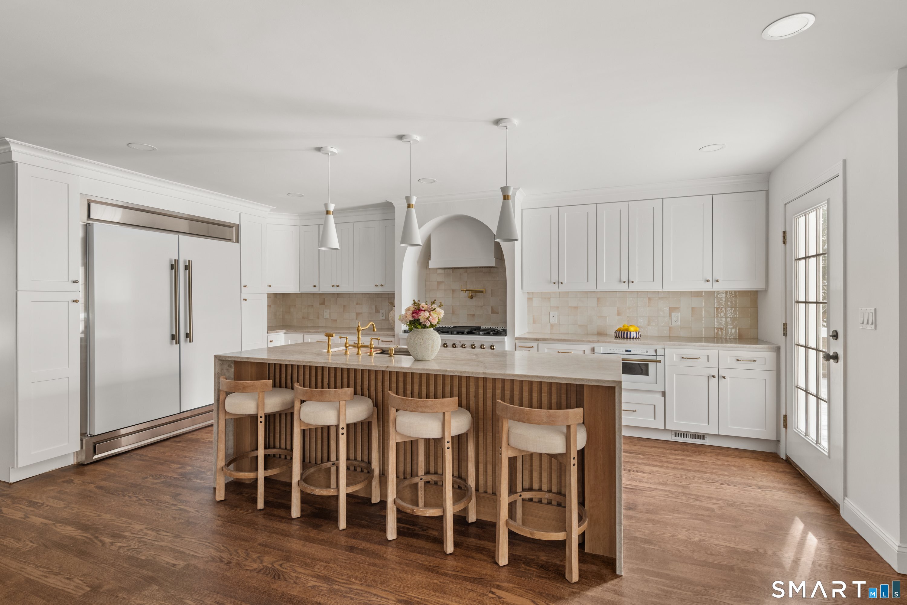 913 Ridgefield Road Wilton, CT 06897 - Photo 17 of 40 a kitchen with granite countertop a table chairs stove a sink and dishwasher