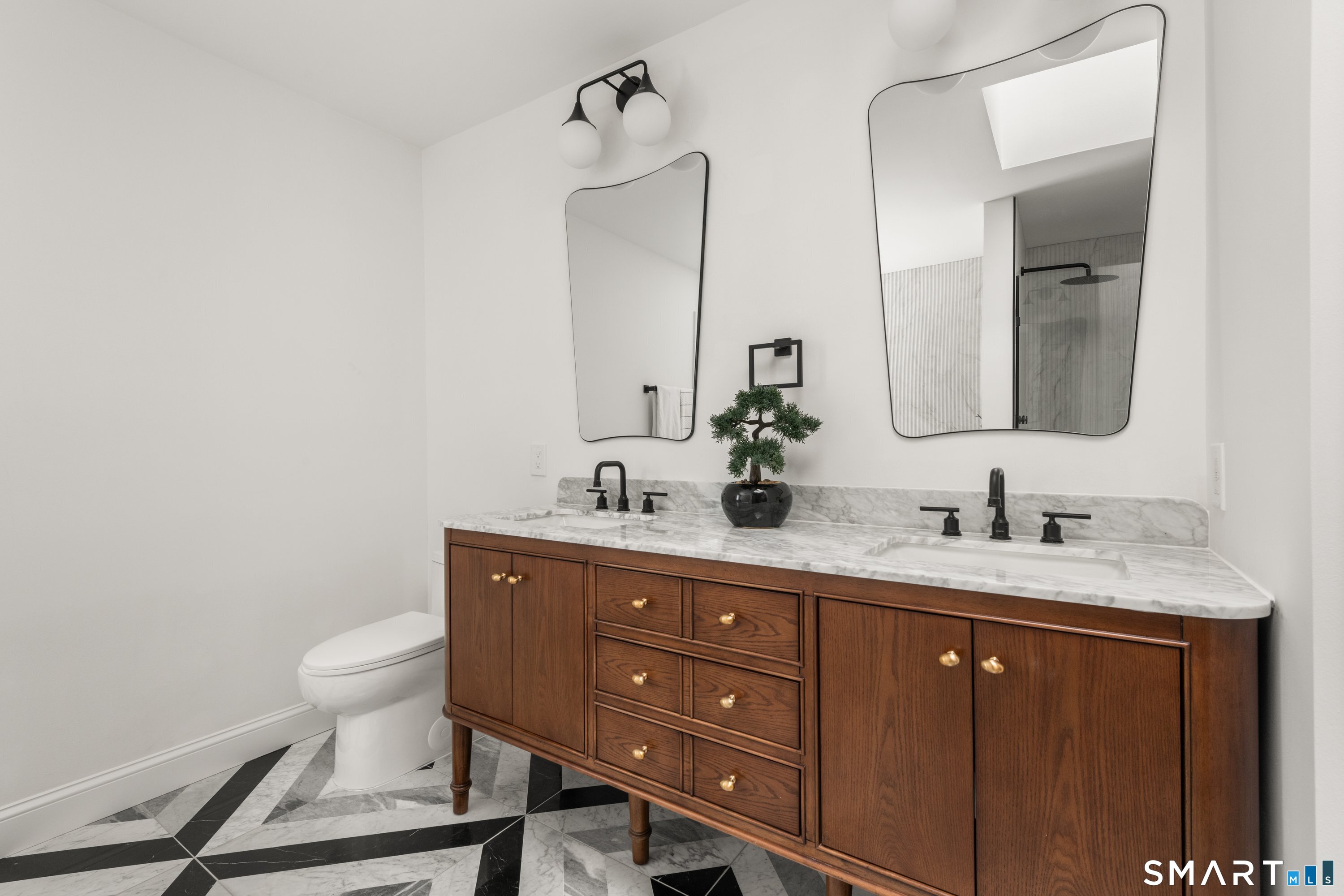 913 Ridgefield Road Wilton, CT 06897 - Photo 29 of 40 a bathroom with a granite countertop sink a toilet and a mirror