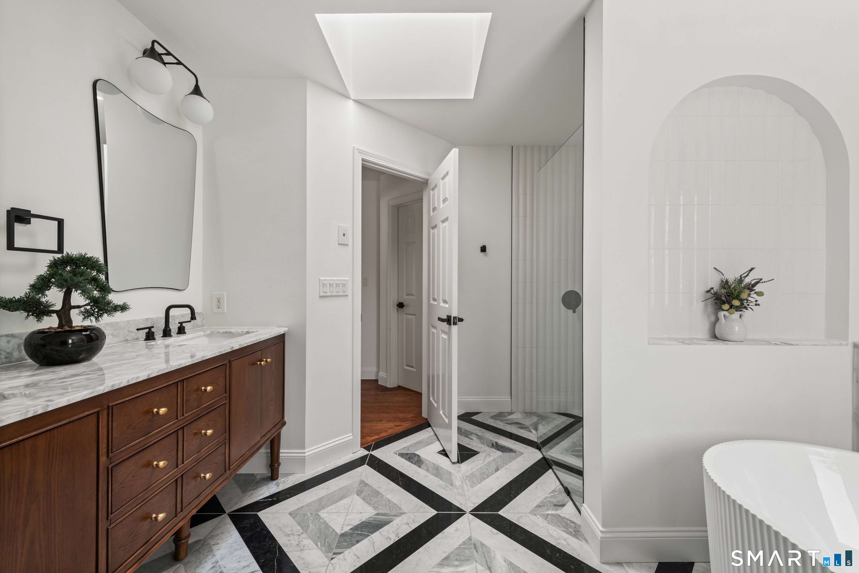 913 Ridgefield Road Wilton, CT 06897 - Photo 30 of 40 a spacious bathroom with a granite countertop sink a toilet a mirror and shower