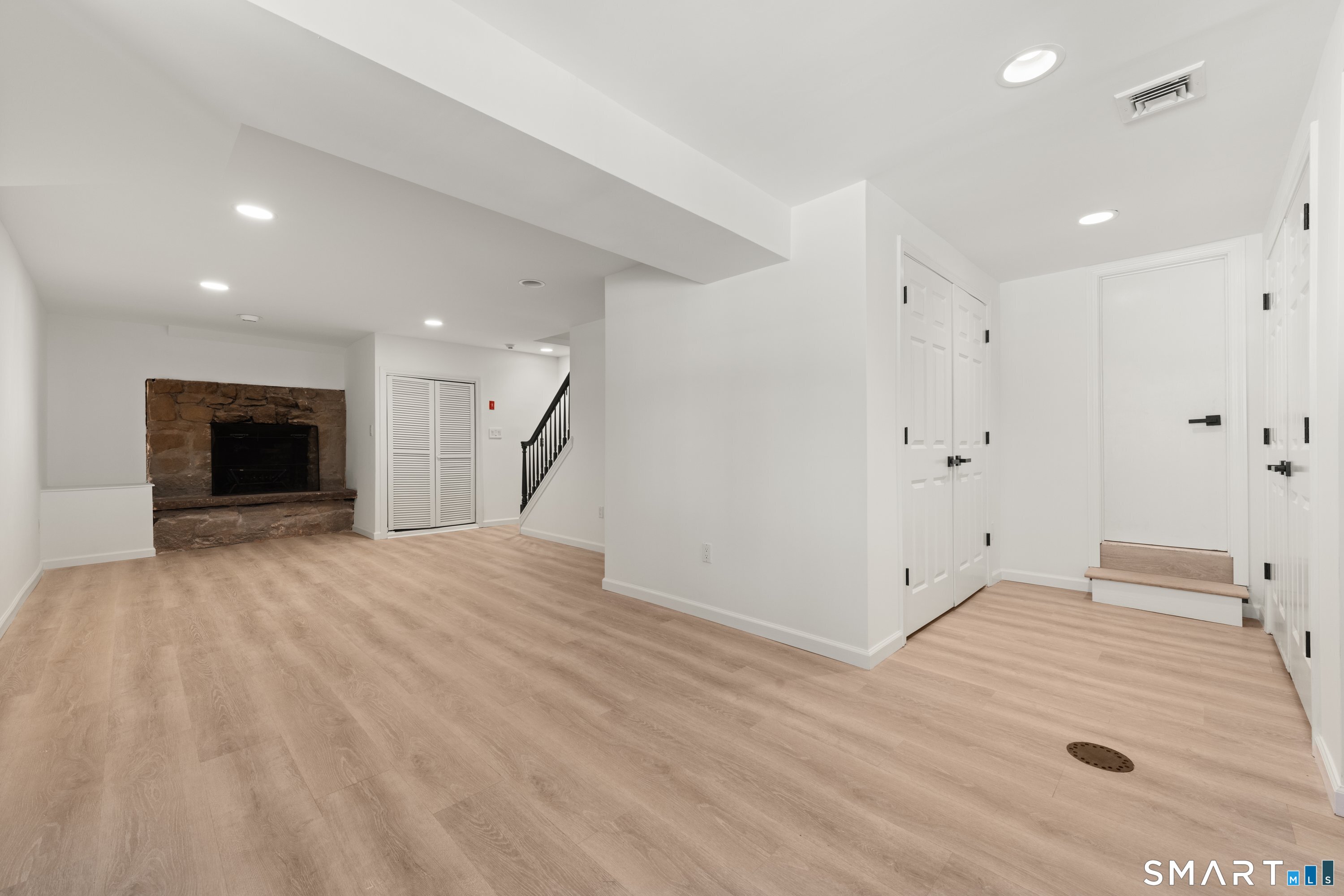 913 Ridgefield Road Wilton, CT 06897 - Photo 36 of 40 a view of empty room with wooden floor and fireplace