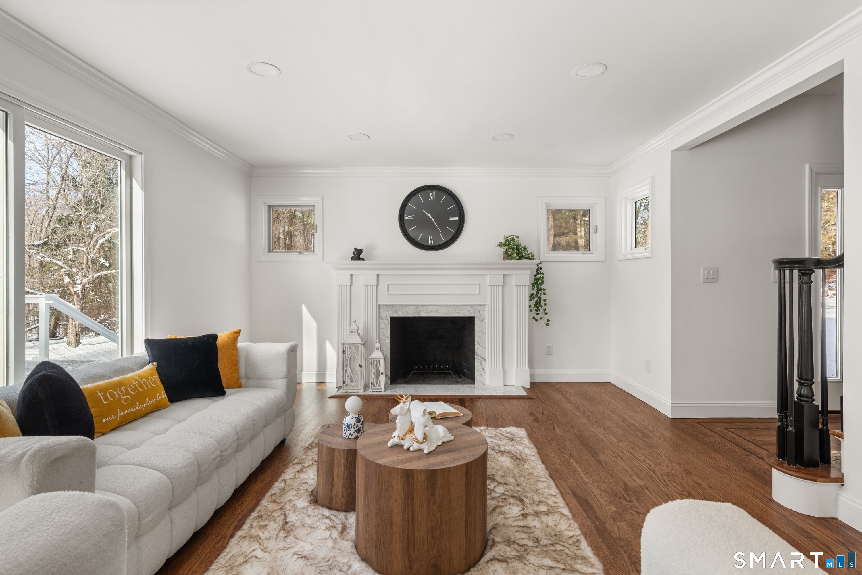 913 Ridgefield Road Wilton, CT 06897 - Photo 10 of 40 a living room with furniture a fireplace and a large window