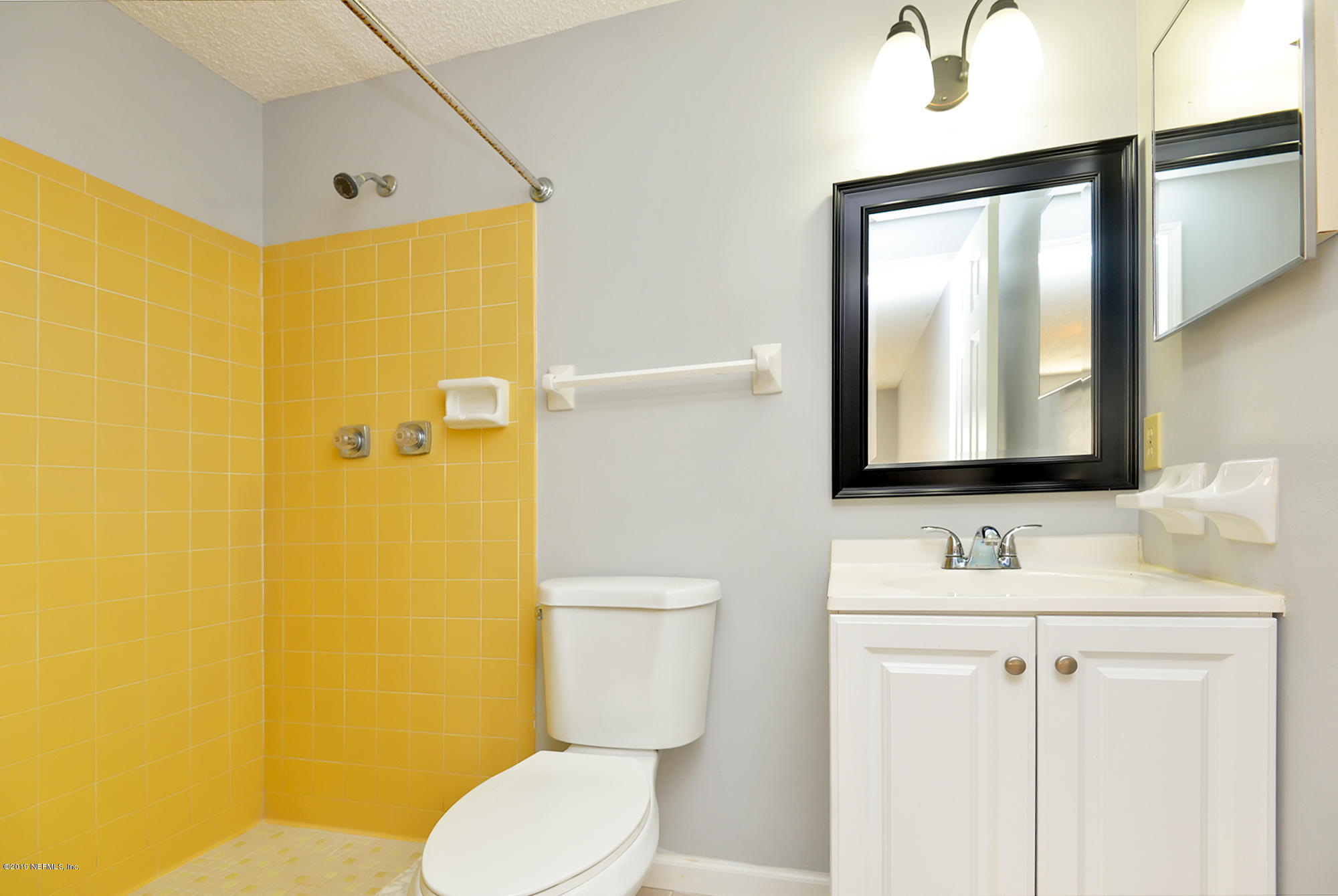2545 Spring Lake Road West Jacksonville, FL 32210 - Photo 13 of 21 a bathroom with a toilet sink and mirror