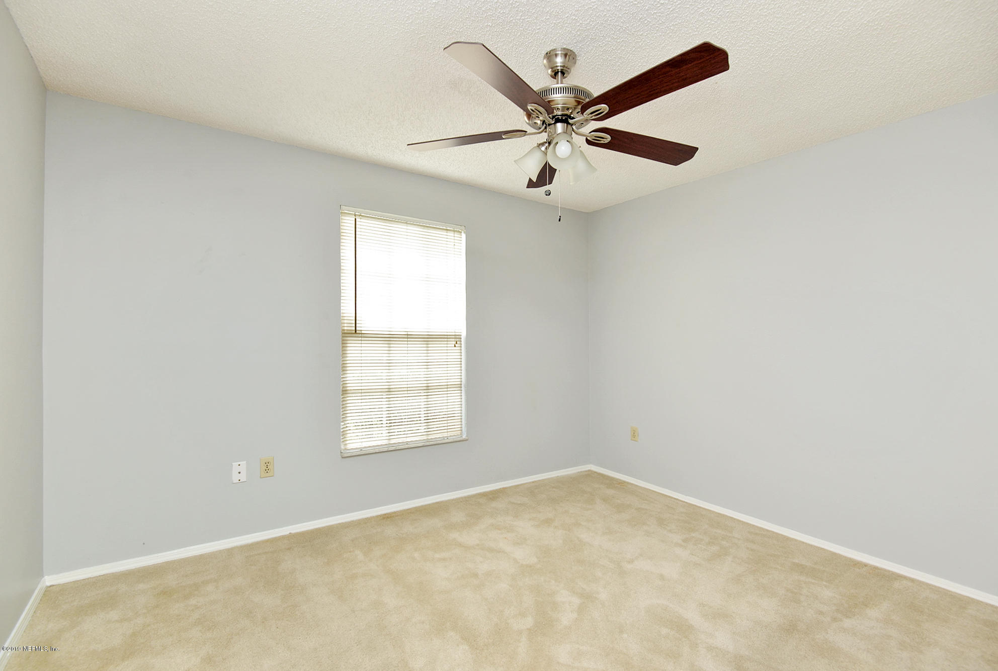 2545 Spring Lake Road West Jacksonville, FL 32210 - Photo 14 of 21 an empty room with a window and a fan