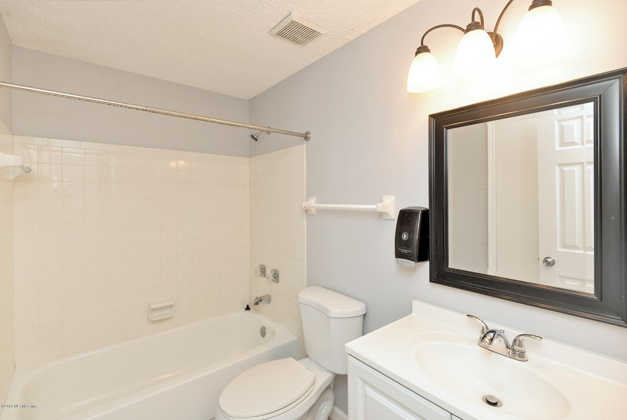 2545 Spring Lake Road West Jacksonville, FL 32210 - Photo 15 of 21 a bathroom with a sink toilet and shower