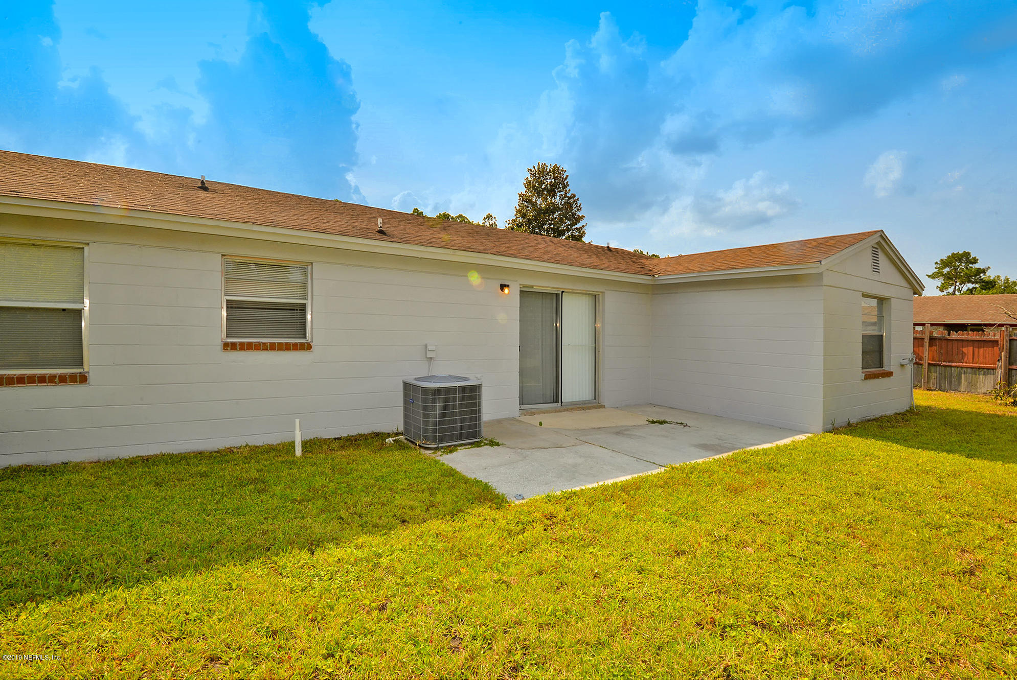 2545 Spring Lake Road West Jacksonville, FL 32210 - Photo 19 of 21 a view of a backyard with a large tree