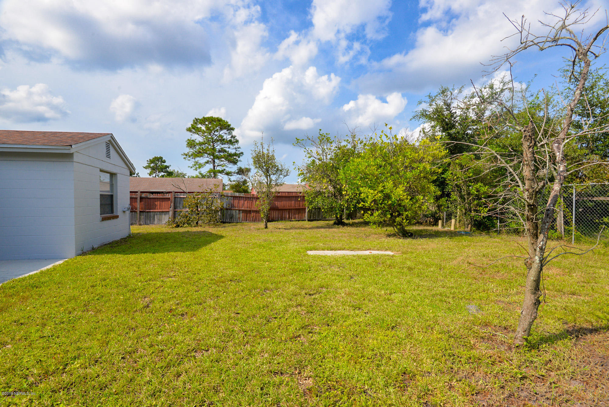 2545 Spring Lake Road West Jacksonville, FL 32210 - Photo 21 of 21 a yellow house with swimming pool in front of it