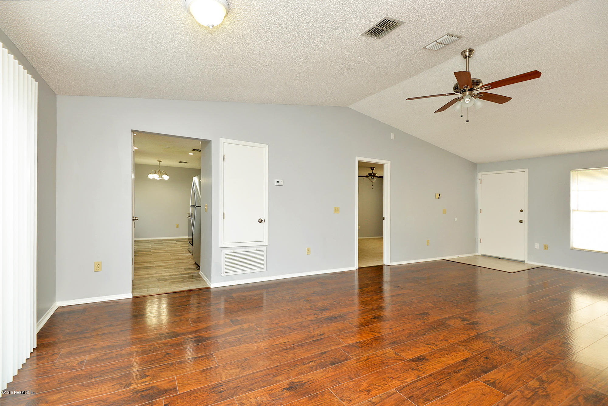 2545 Spring Lake Road West Jacksonville, FL 32210 - Photo 6 of 21 wooden floor in an empty room with a window