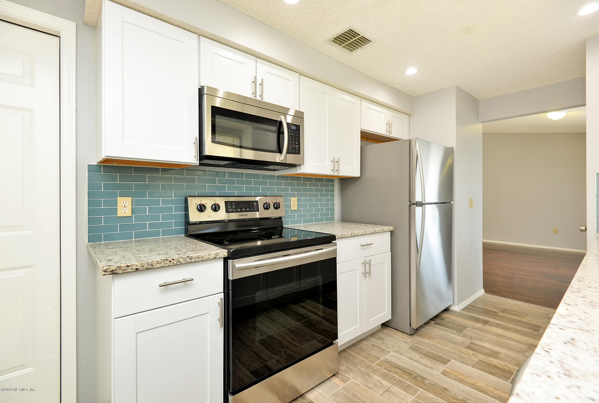 2545 Spring Lake Road West Jacksonville, FL 32210 - Photo 8 of 21 a kitchen with stainless steel appliances granite countertop a stove a refrigerator and a microwave