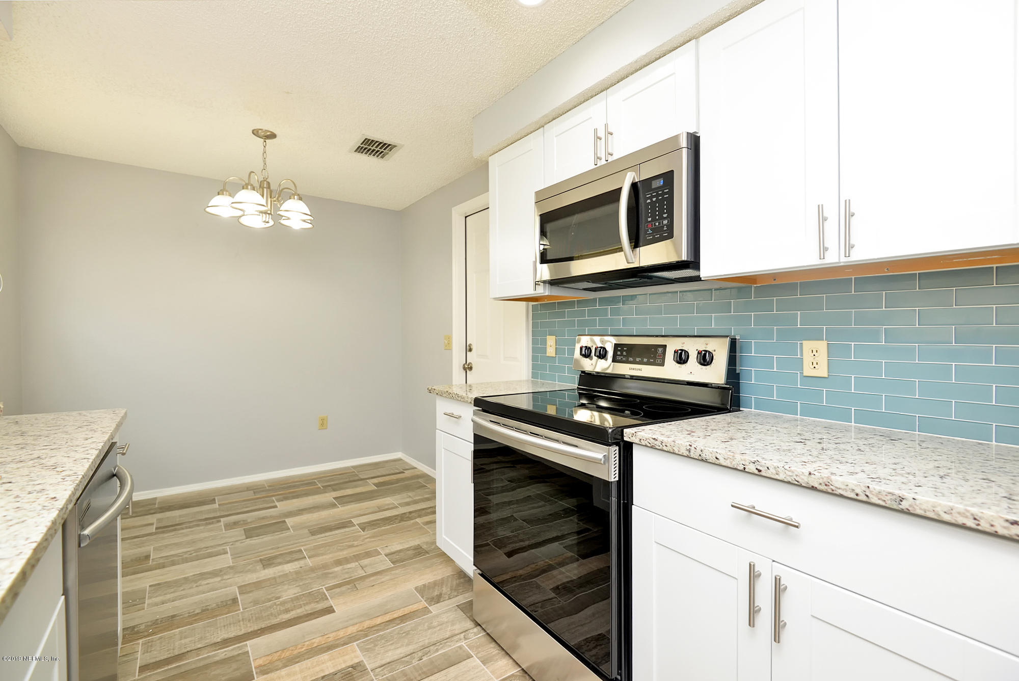 2545 Spring Lake Road West Jacksonville, FL 32210 - Photo 9 of 21 a kitchen with a stove and a microwave