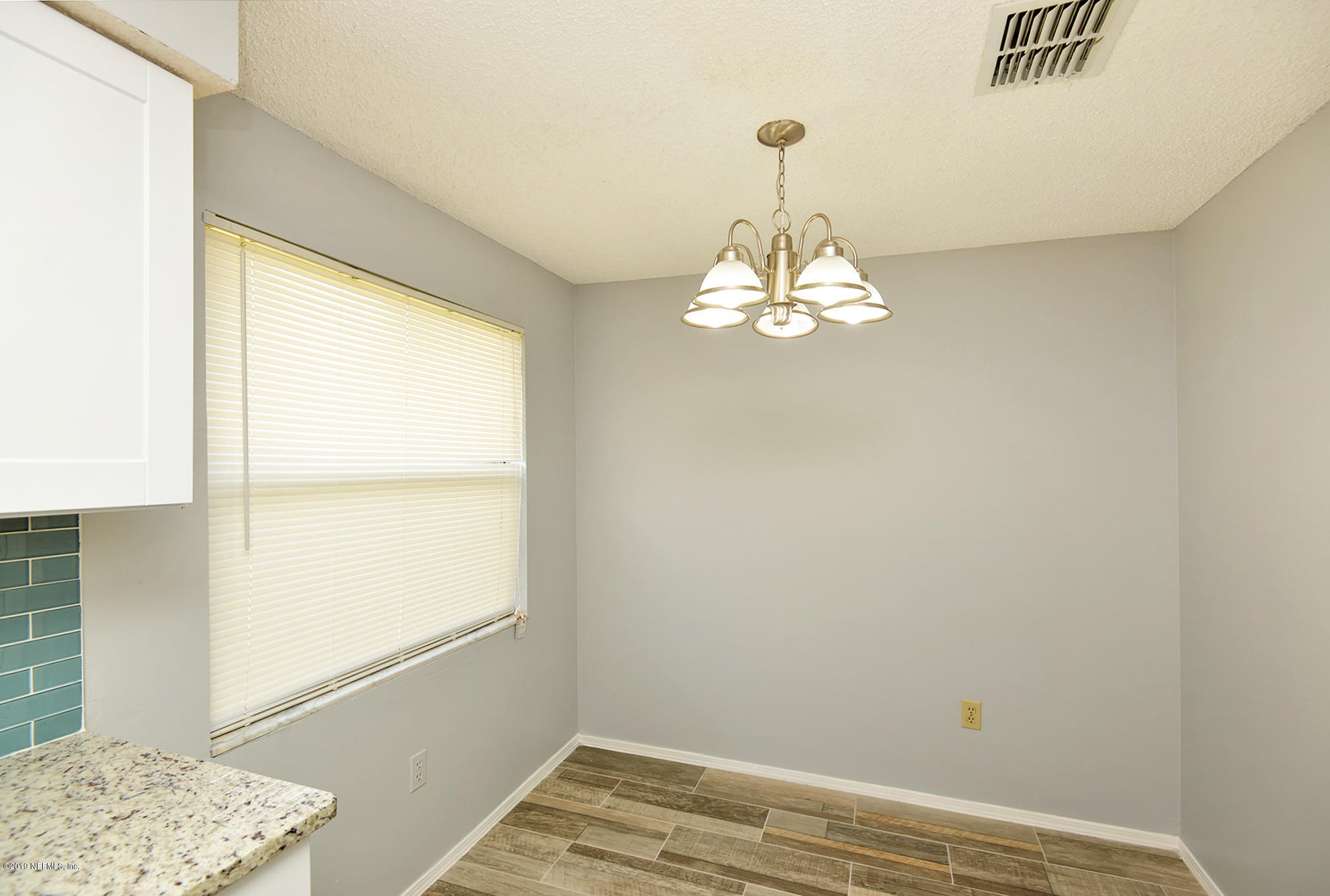 2545 Spring Lake Road West Jacksonville, FL 32210 - Photo 10 of 21 a view of a bedroom with wooden floor and a window