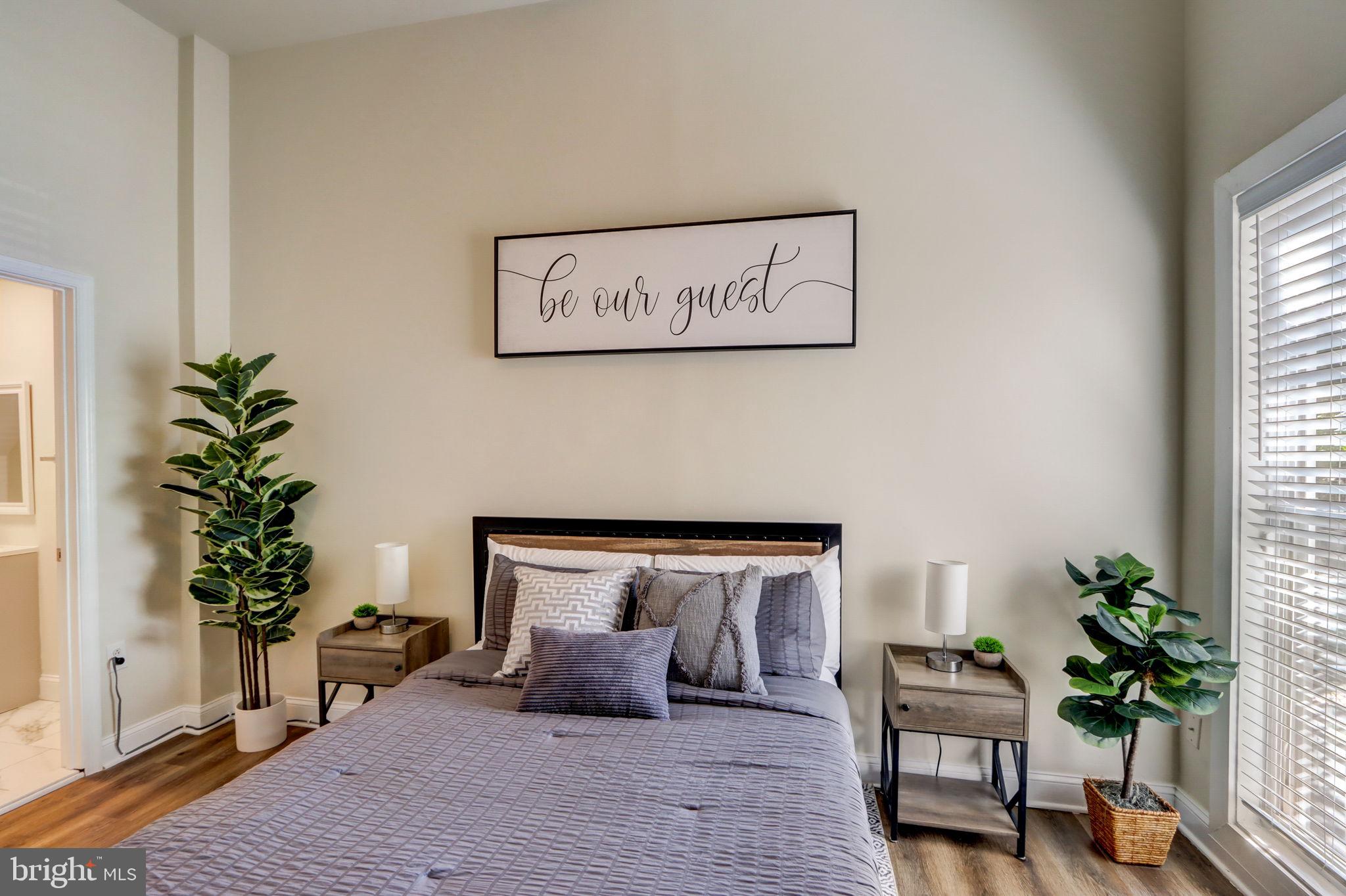 1628 North Calvert Street Baltimore, MD 21202 - Photo 15 of 63 a bedroom with furniture and a potted plant