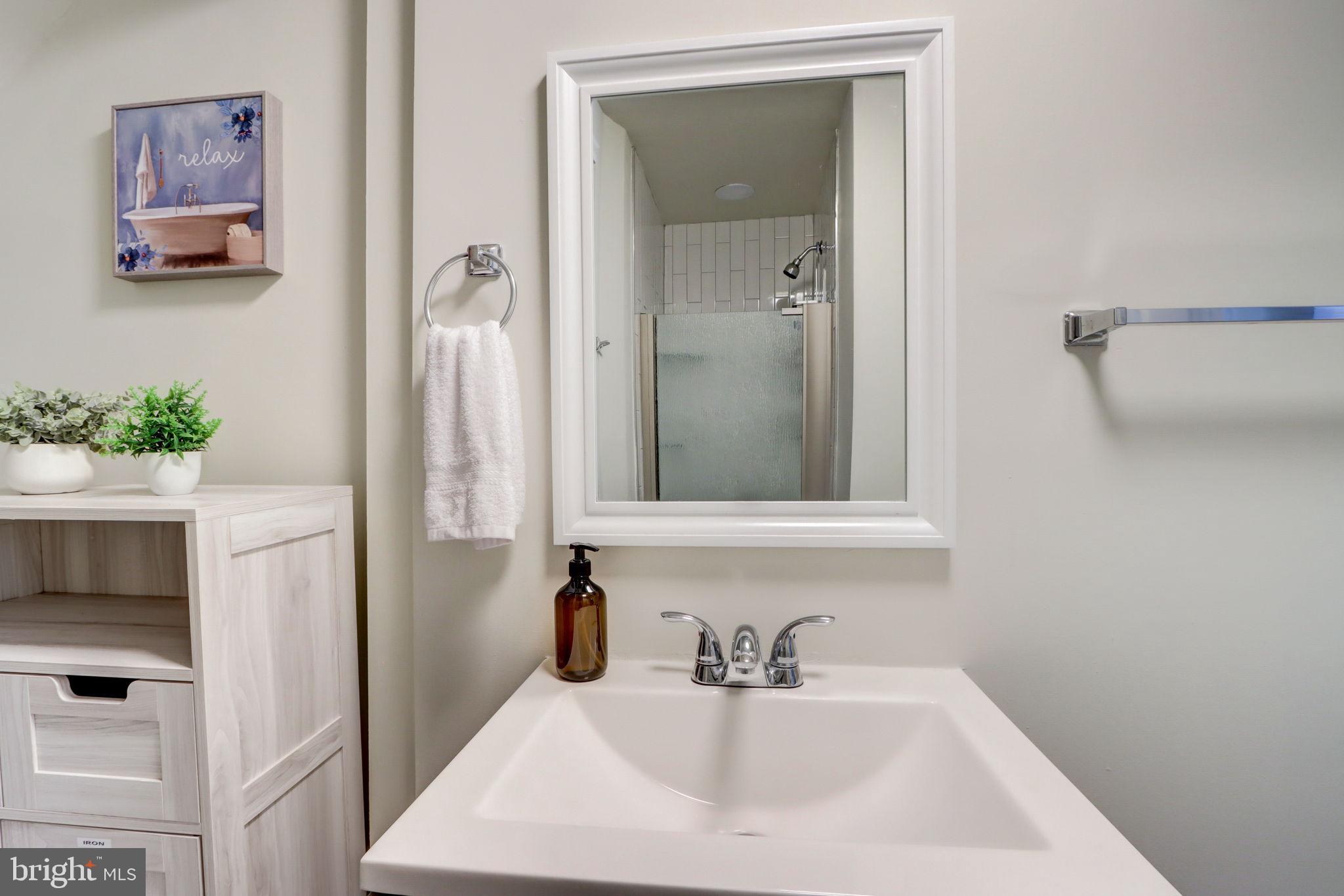 1628 North Calvert Street Baltimore, MD 21202 - Photo 17 of 63 a bathroom with a sink and a mirror
