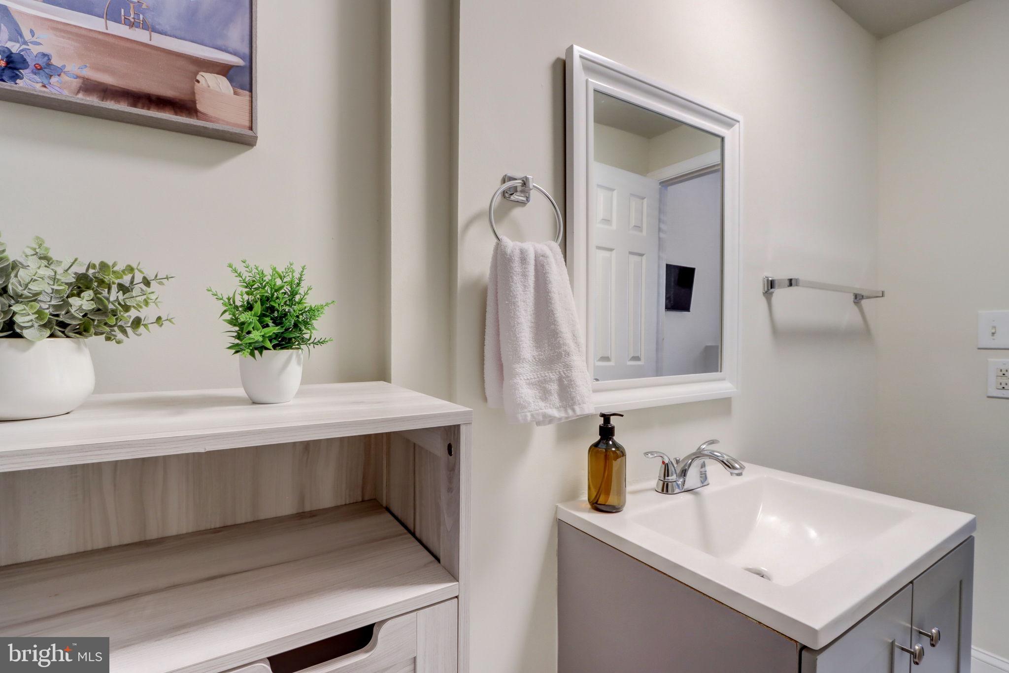 1628 North Calvert Street Baltimore, MD 21202 - Photo 18 of 63 a bathroom with a sink and a mirror