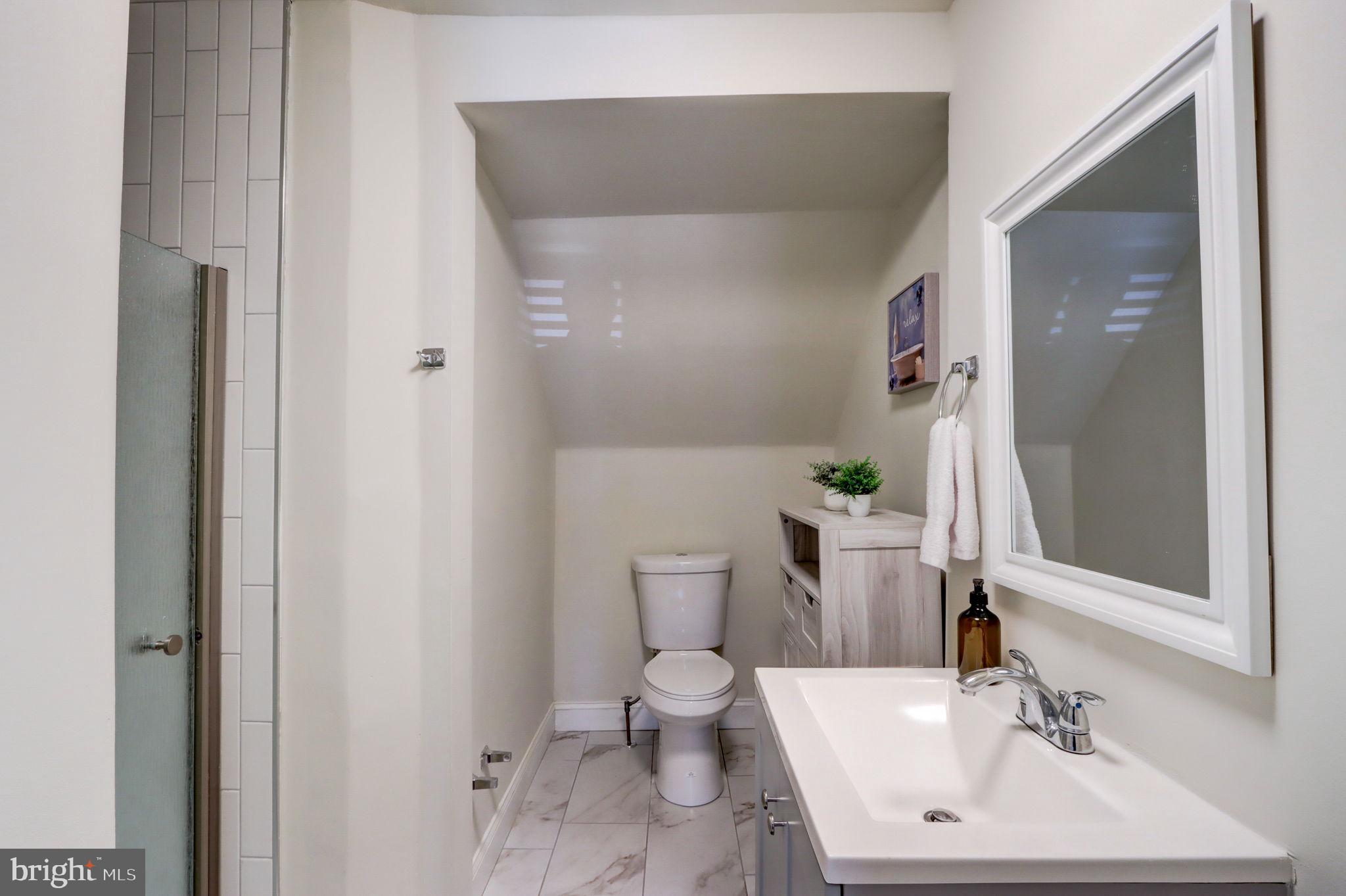 1628 North Calvert Street Baltimore, MD 21202 - Photo 19 of 63 a bathroom with a sink toilet and shower