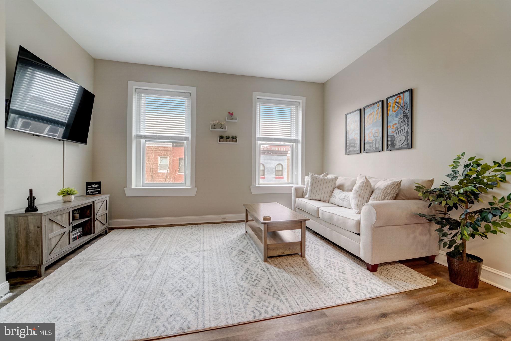 1628 North Calvert Street Baltimore, MD 21202 - Photo 50 of 63 a living room with furniture and a flat screen tv