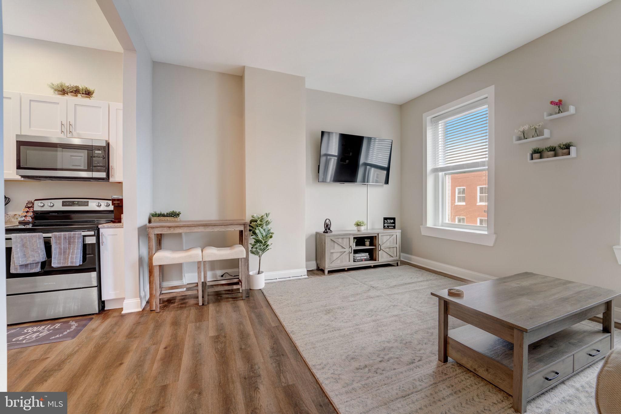 1628 North Calvert Street Baltimore, MD 21202 - Photo 51 of 63 a living room with furniture and a flat screen tv