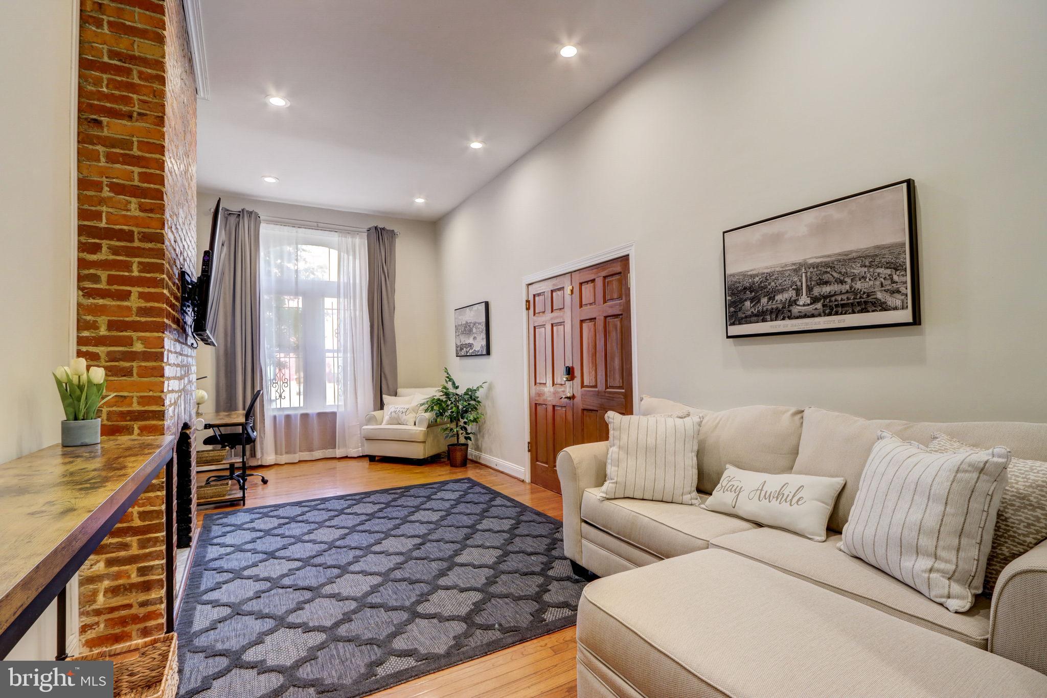 1628 North Calvert Street Baltimore, MD 21202 - Photo 6 of 63 a living room with furniture and a large window