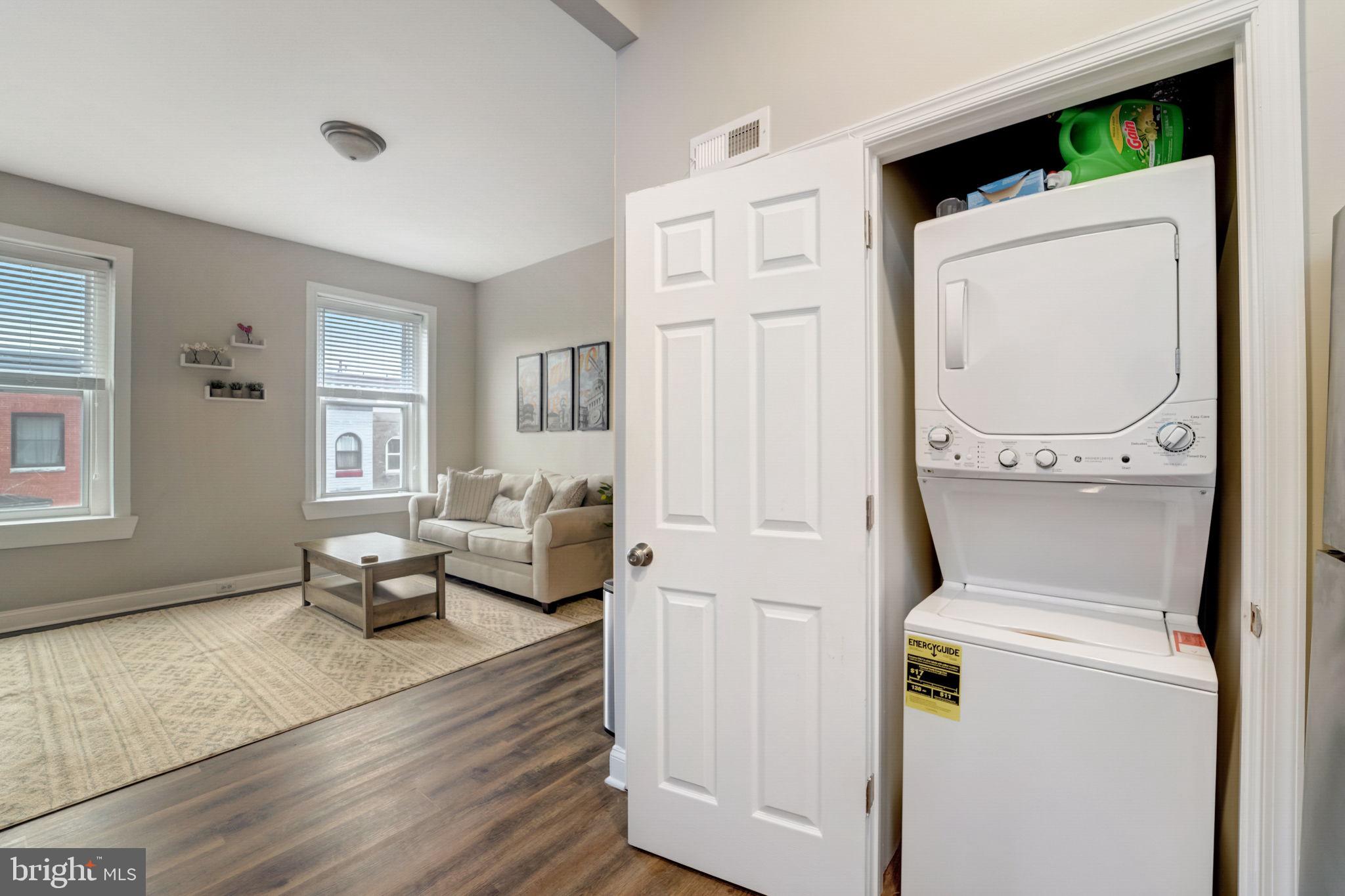 1628 North Calvert Street Baltimore, MD 21202 - Photo 63 of 63 a living room with furniture and a wooden floor
