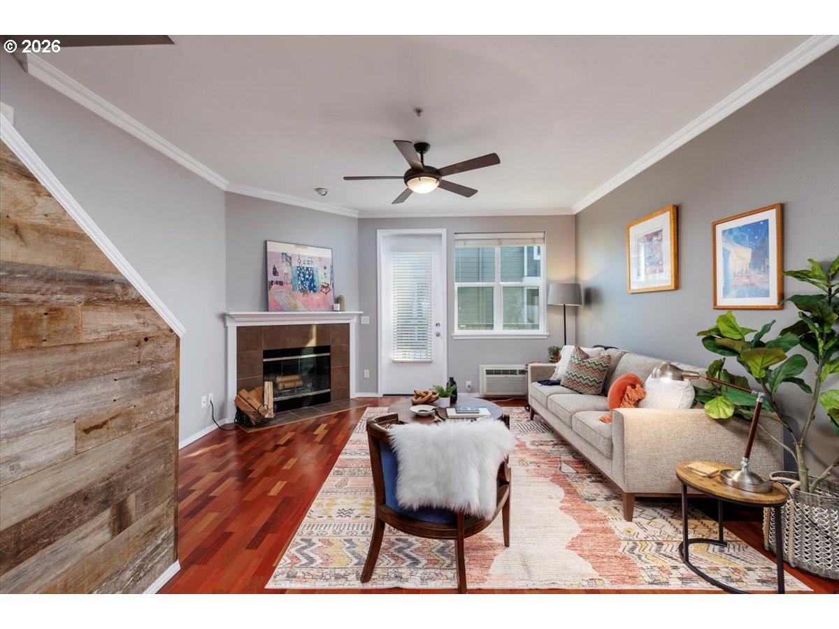 723 Southeast Fairwinds Loop, Unit BLDG H Vancouver, WA 98661 - Photo 11 of 34 a living room with furniture a fireplace and a flat screen tv