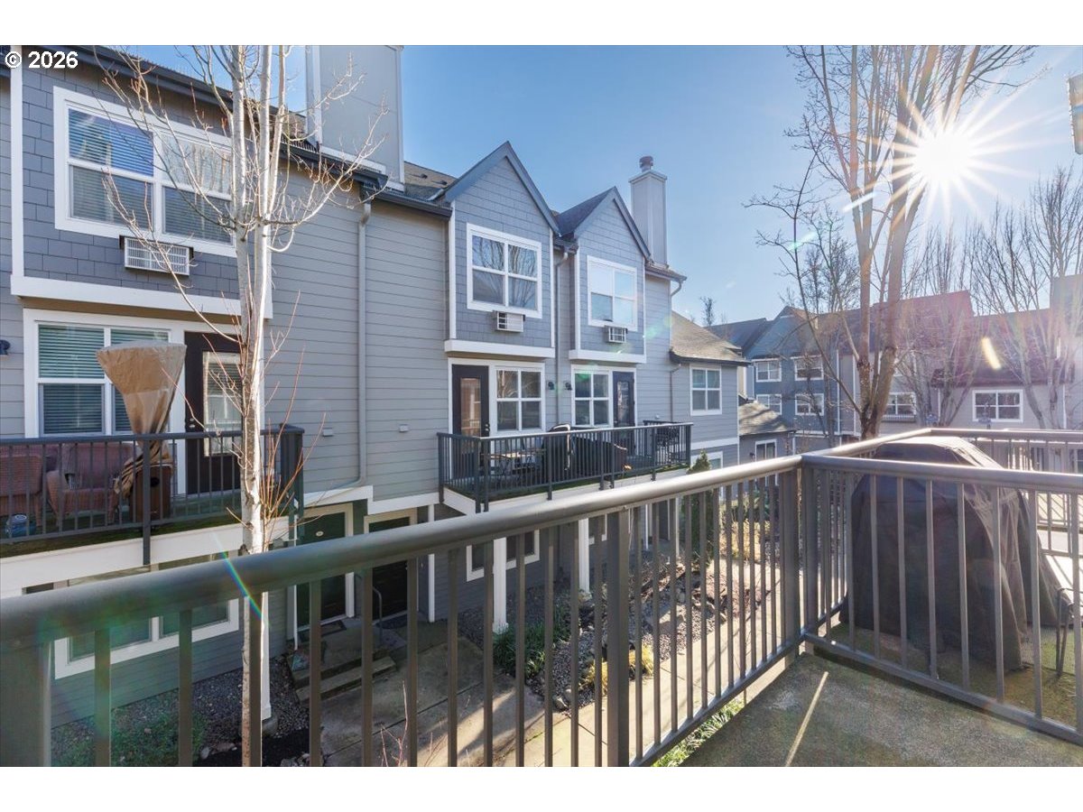 723 Southeast Fairwinds Loop, Unit BLDG H Vancouver, WA 98661 - Photo 13 of 34 a view of a brick house with a small yard and wooden fence