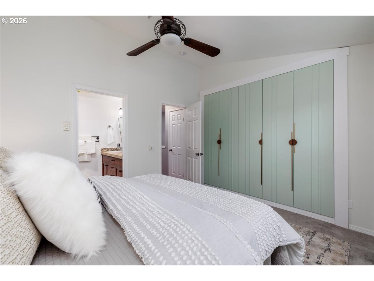 723 Southeast Fairwinds Loop, Unit BLDG H Vancouver, WA 98661 - Photo 15 of 34 a bedroom with a bed and a chandelier