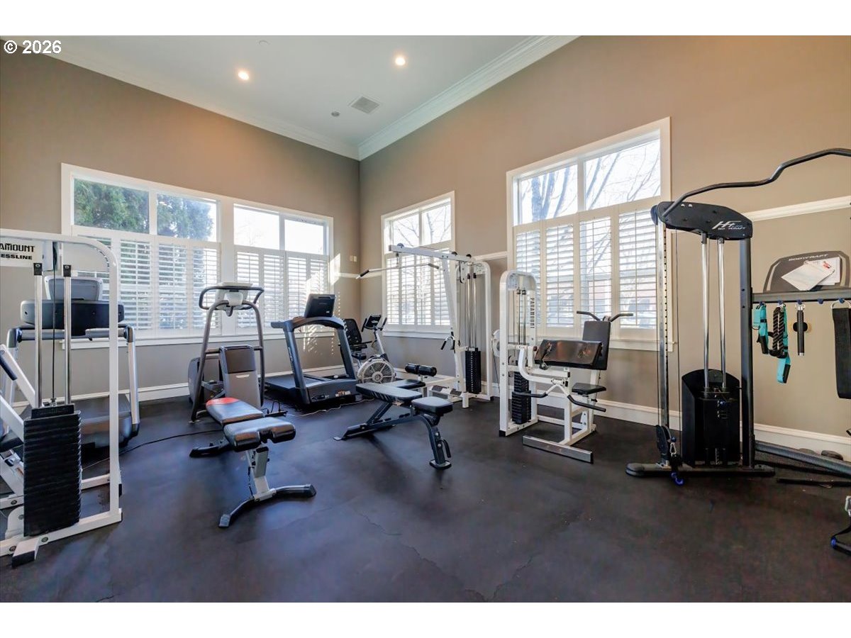 723 Southeast Fairwinds Loop, Unit BLDG H Vancouver, WA 98661 - Photo 27 of 34 a living room with furniture gym equipment and a large window