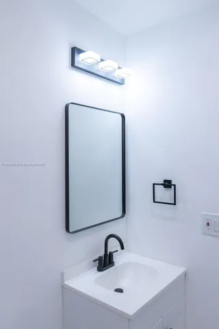 a bathroom with a sink and mirror