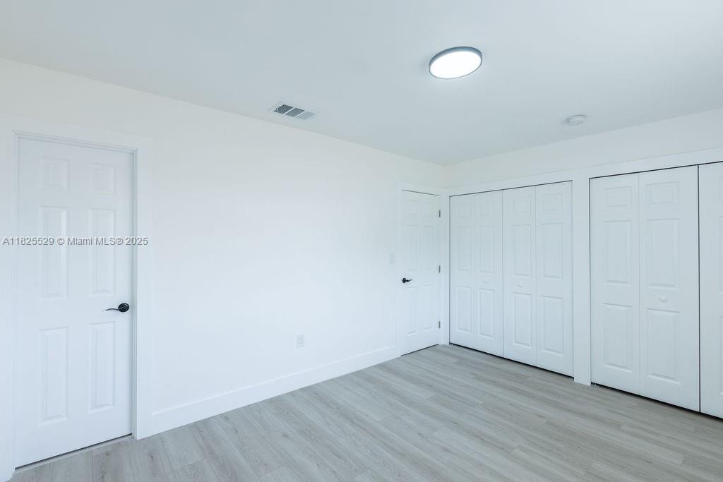 355 Southwest 17th Avenue Homestead, FL 33030 - Photo 15 of 21 a view of an empty room with wooden floor