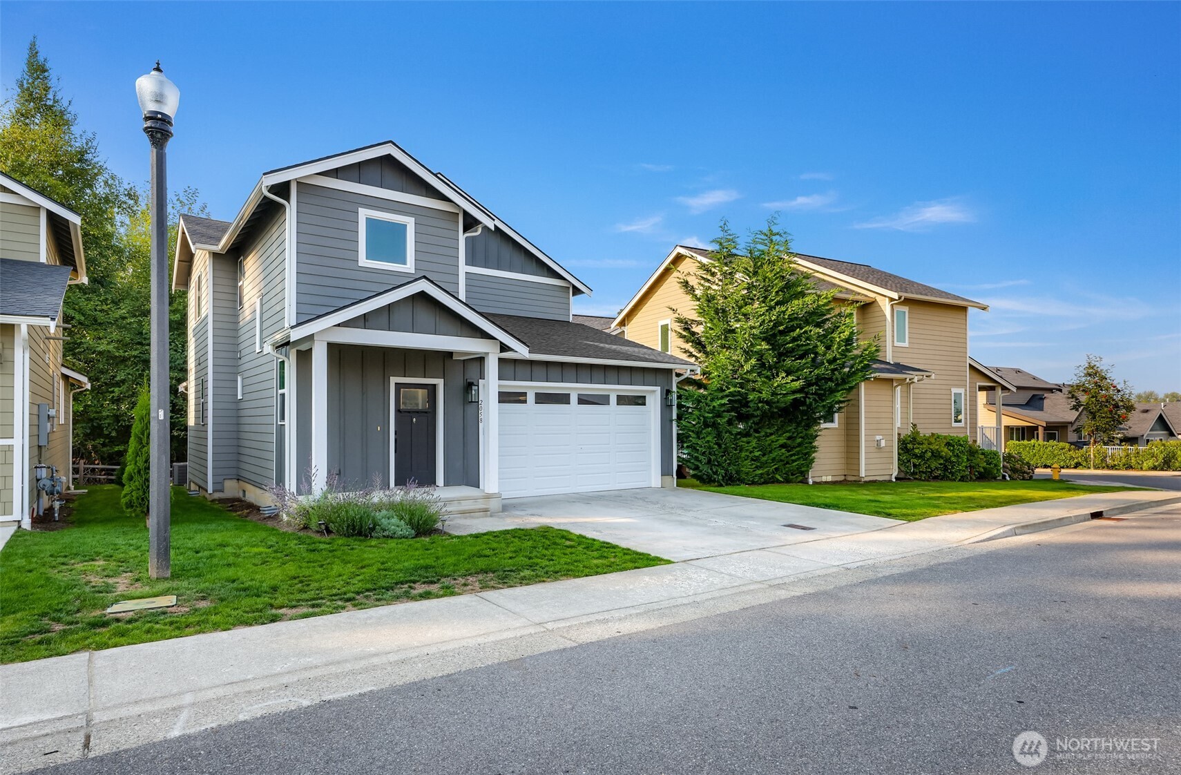2058 Andre Court Ferndale, WA 98248 - Photo 2 of 39 a front view of a house with a yard and garage
