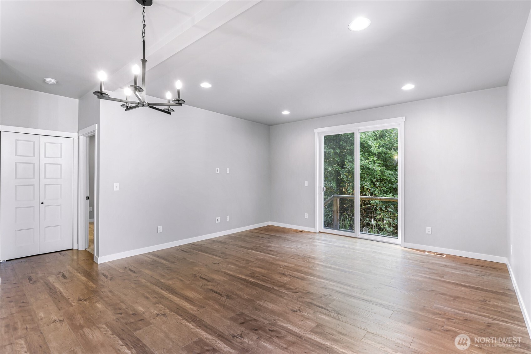 2058 Andre Court Ferndale, WA 98248 - Photo 21 of 39 a view of an empty room with wooden floor ceiling fan and a window
