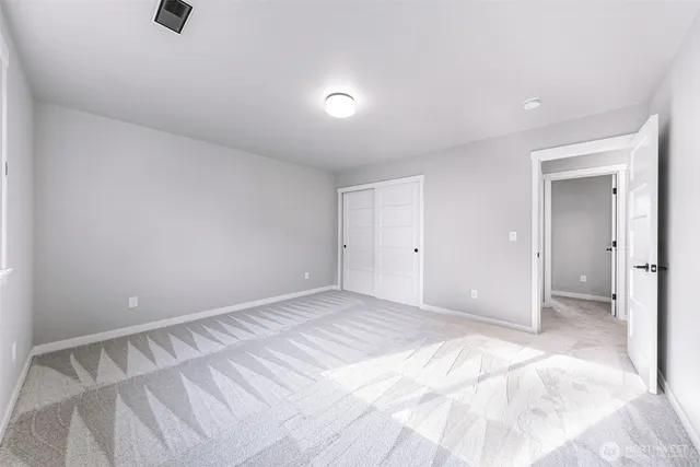 a view of an empty room and closet area