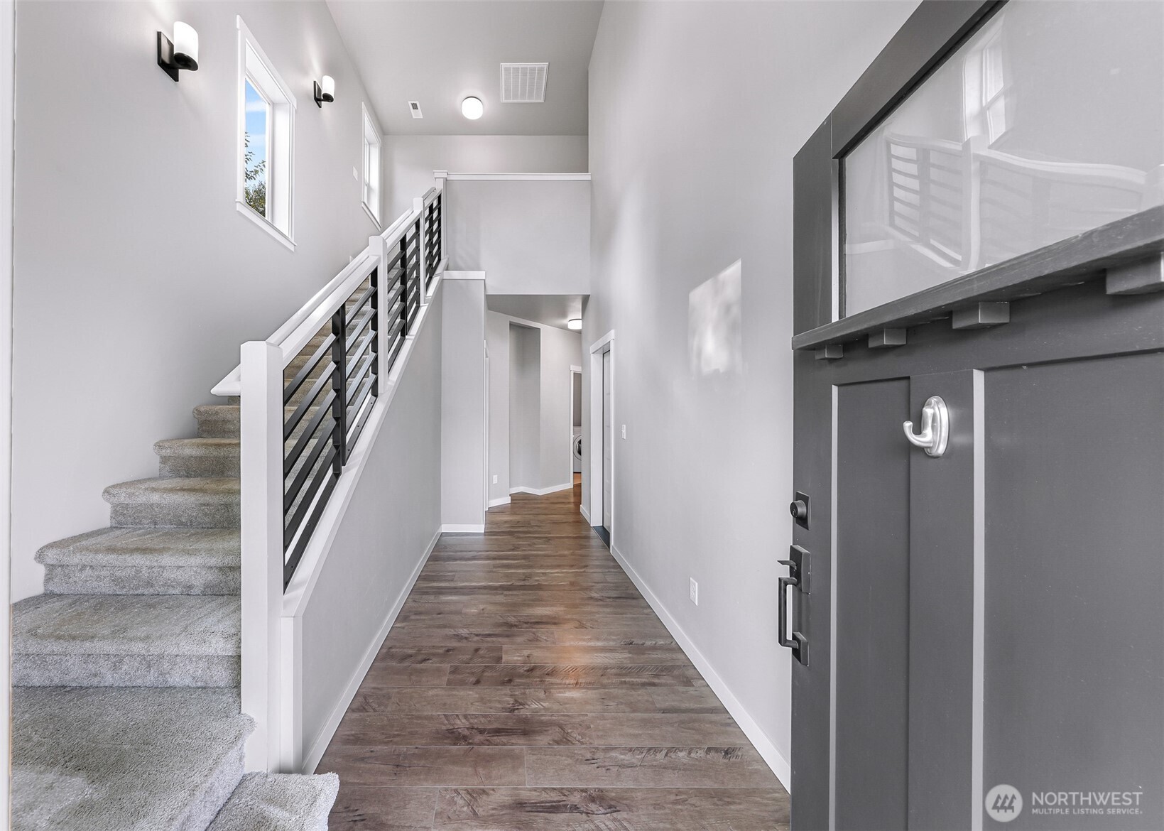 2058 Andre Court Ferndale, WA 98248 - Photo 4 of 39 a view of staircase with lots of frames on wall and a window