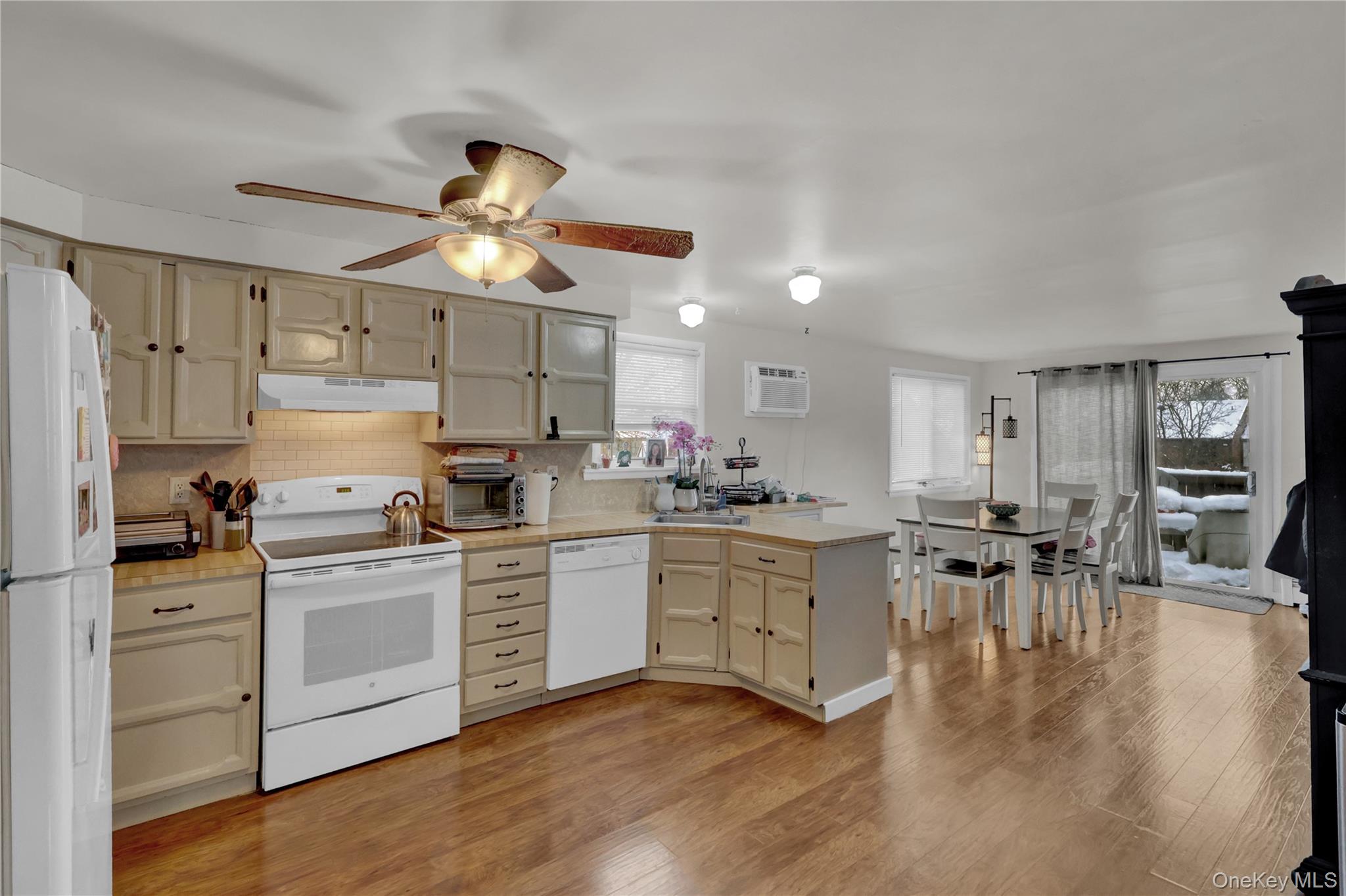 199 August Road North Babylon, NY 11703 - Photo 19 of 32 2nd floor Kitchen featuring a peninsula, white appliances, light countertops, and plenty of natural light