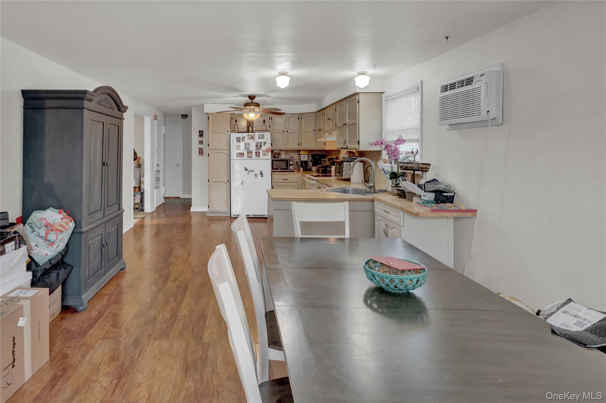 199 August Road North Babylon, NY 11703 - Photo 21 of 32 2nd floor Dining room featuring light wood-style floors, a wall mounted air conditioner, and ceiling fan