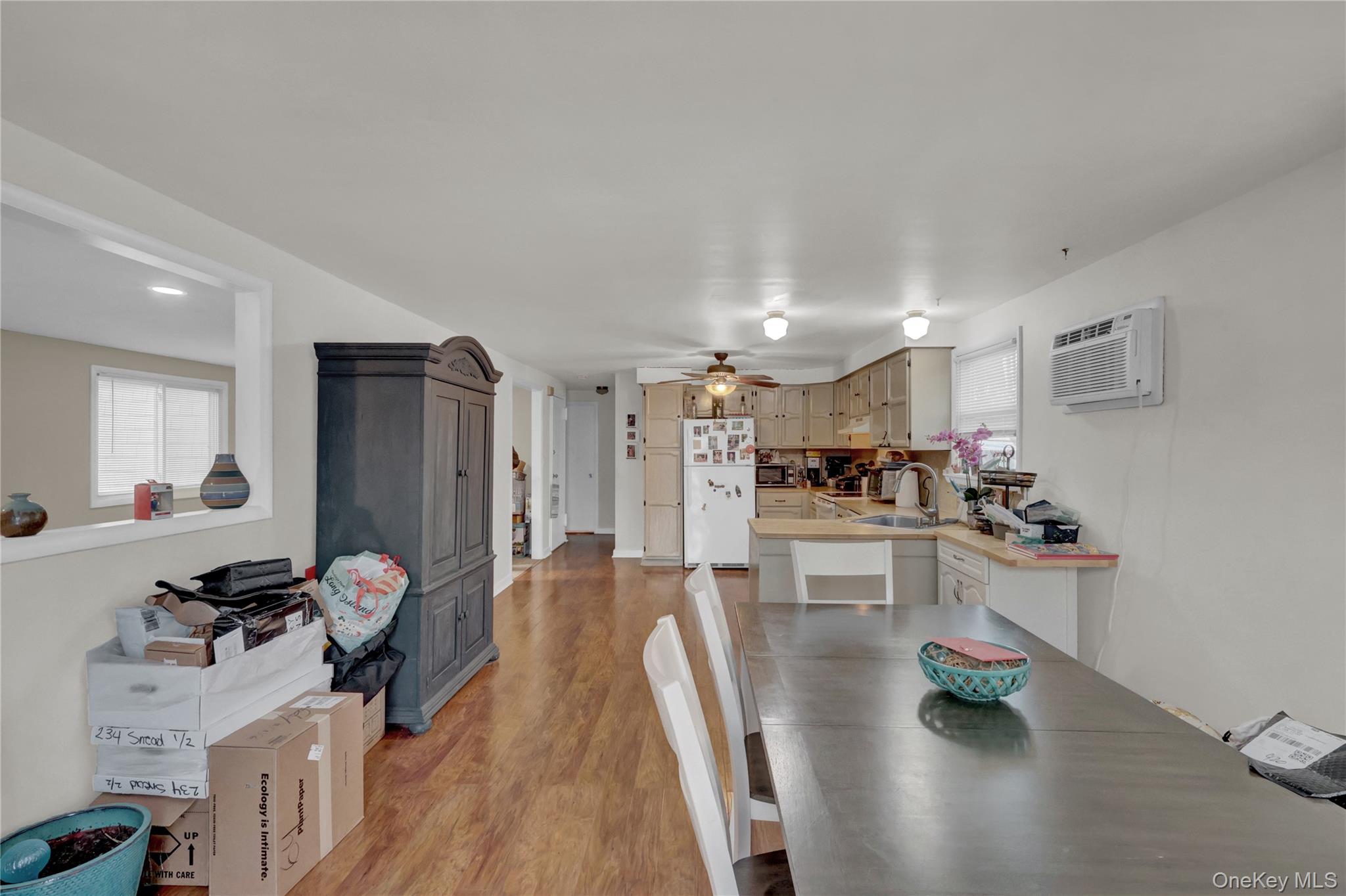 199 August Road North Babylon, NY 11703 - Photo 22 of 32 2nd floor Dining room with light wood-style floors, a wall mounted AC, and ceiling fan