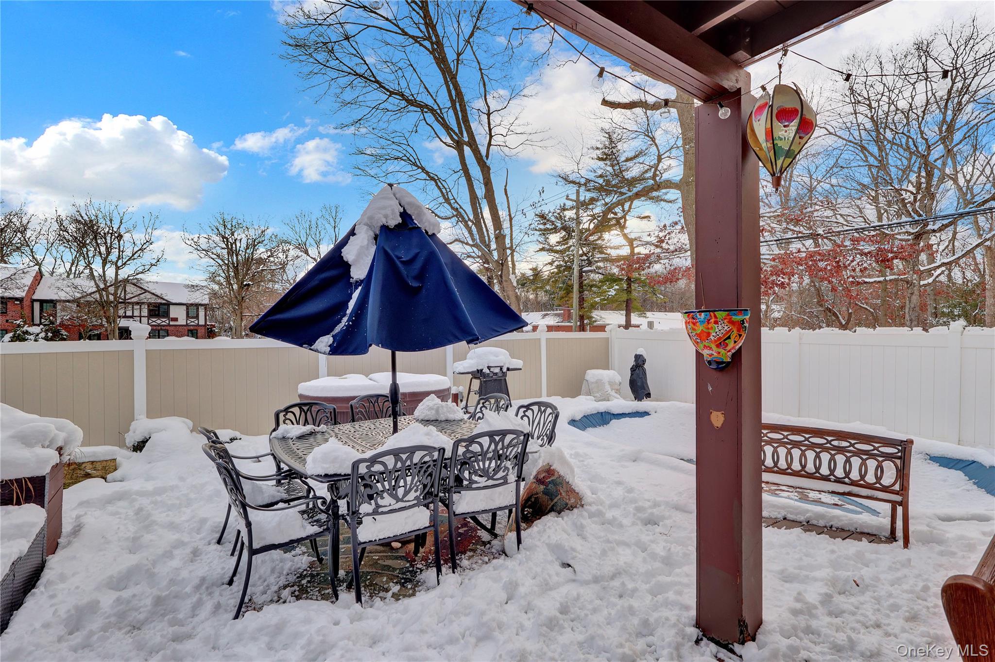 199 August Road North Babylon, NY 11703 - Photo 29 of 32 Snow covered patio with a fenced backyard, outdoor dining space, and grilling area