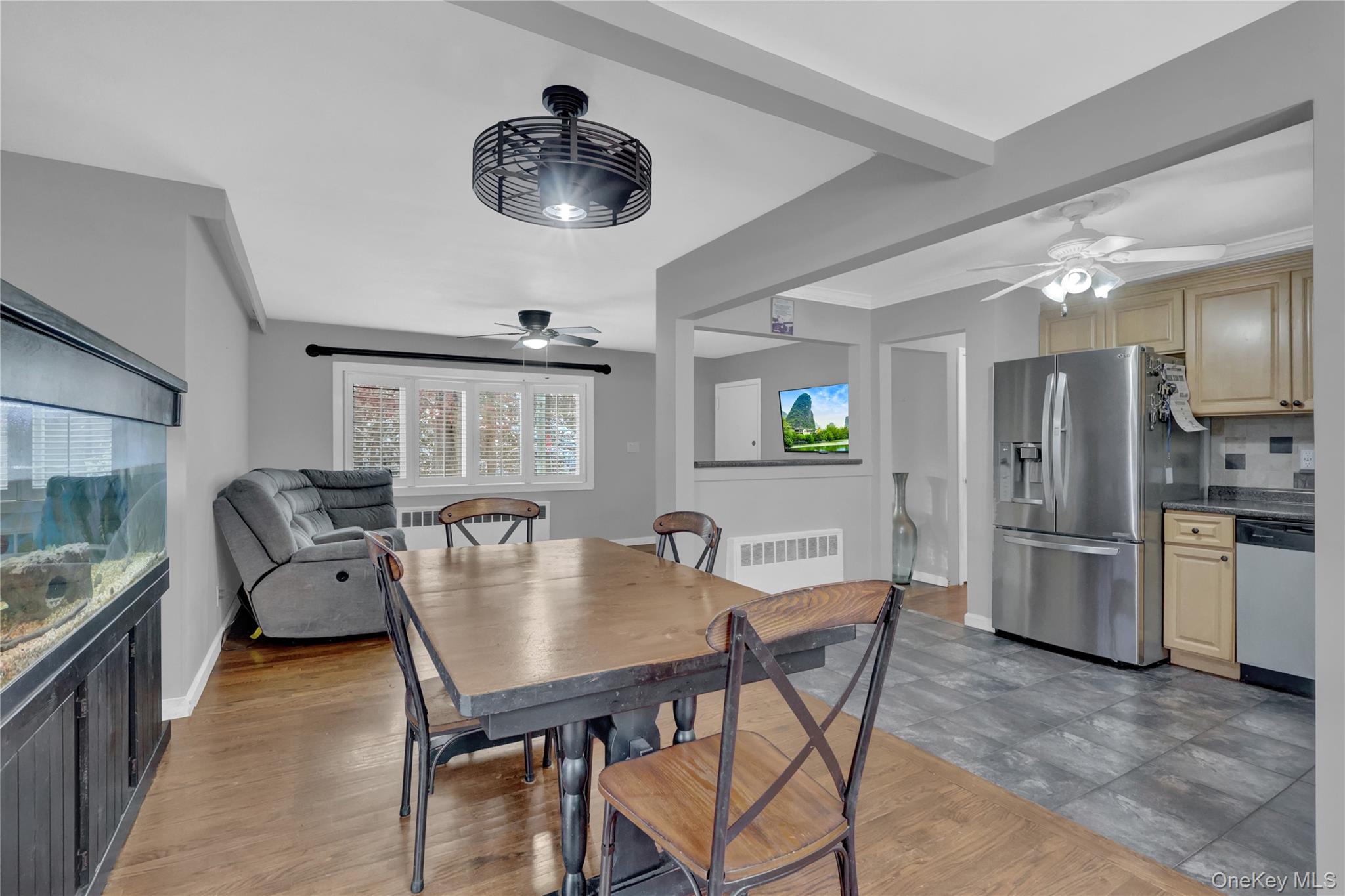 199 August Road North Babylon, NY 11703 - Photo 9 of 32 Dining area with a ceiling fan and radiator heating unit