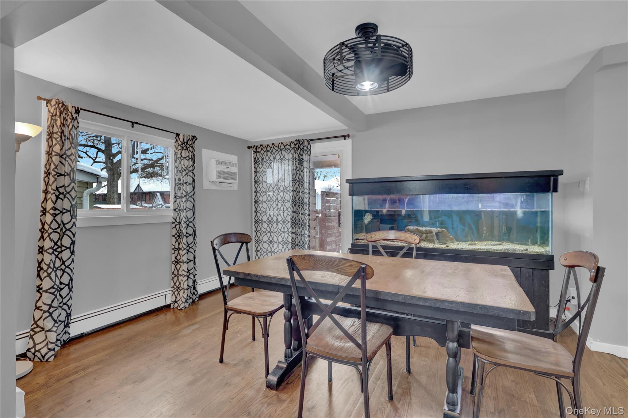 199 August Road North Babylon, NY 11703 - Photo 10 of 32 Dining space featuring light wood-type flooring, a baseboard heating unit, and a wall unit AC